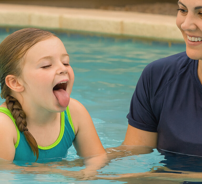 Instructor providing swim lessons in a home pool, .